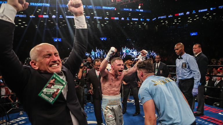 Carl Frampton (C) celebrates winning the WBA featherwight title with trainer Shane McGuigan (R) and manager Barry McGuigan (L)