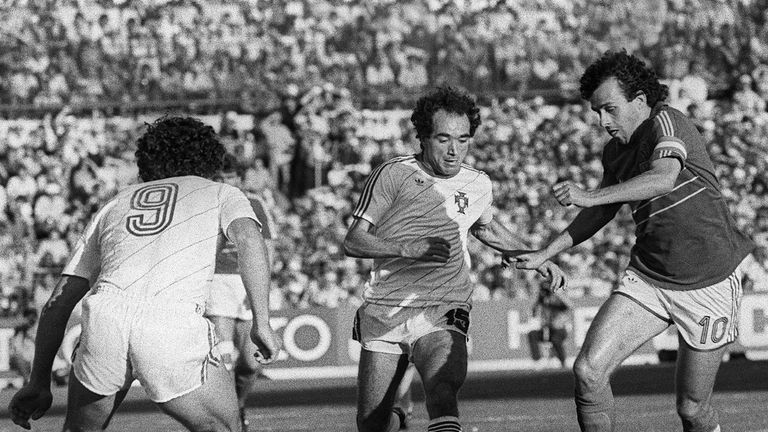 French captain Michel Platini (R) tries to dribble by Portuguese Jaime Pacheco (C) as Joao Pinto looks on