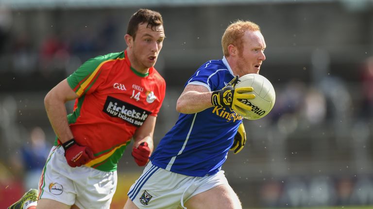 Cian Mackey is tracked by Darragh Foley of Carlow