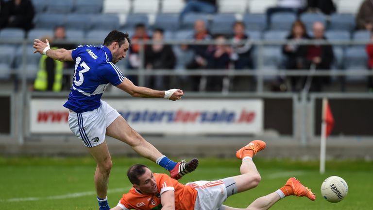 Conor Meredith scores a goal against Armagh despite the efforts of Andy Mallon