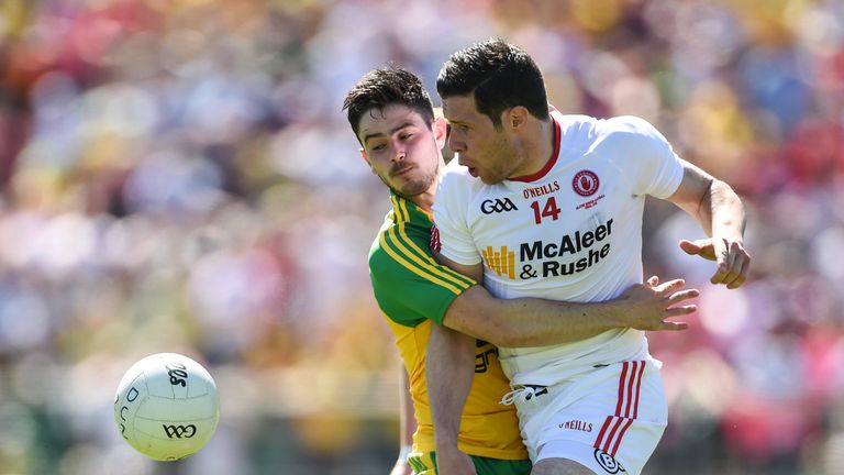Tyrone captain Sean Cavanagh is tackled by Ryan McHugh of Donegal 