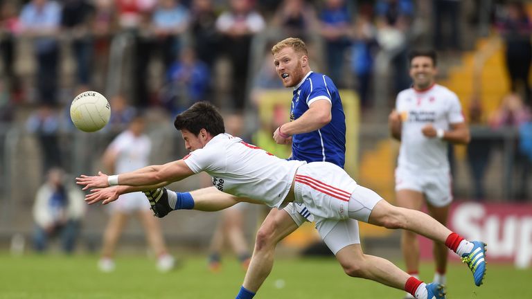 James McEnroe of Cavan is tackled by Mattie Donnelly of Tyrone during the Ulster GAA Football Senior Championship Semi-Final at St Tiemach's Park