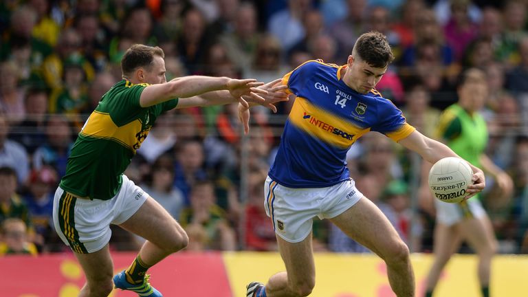 Michael Quinlivan is tackled by Mark Griffin of Kerry