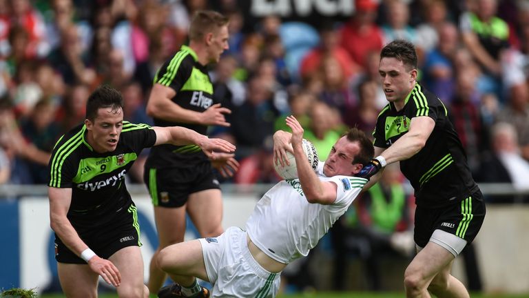 Ruairí Corrigan is tackled by Mayo's Patrick Durcan
