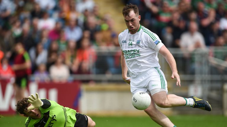 Sean Quigley rounds Mayo goalkeeper David Clarke to score a goal