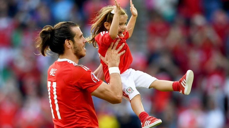 Gareth Bale celebrates with his daughter after Wales beat Northern Ireland