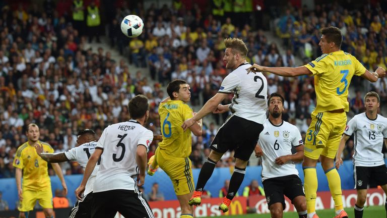 Germany's defender Shkodran Mustafi (2nd-R) jumps to head the ball between Ukraine's midfielder Taras Stepanenko (C) and Ukraine's defender Yevhen Khacheri