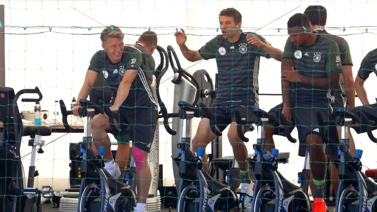 (L-R) Bastian Schweinsteiger, Thomas Muller and Jerome Boateng of Germany warm up on bikes before training