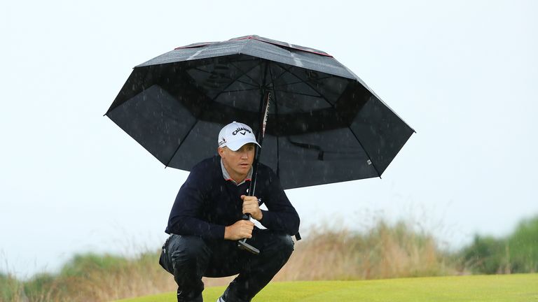 INVERNESS, SCOTLAND - JULY 09:  Alex Noren of Sweden holds an umbrella as he lines up a putt during the third round of the AAM Scottish Open at Castle Stua