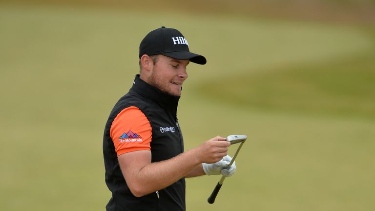 INVERNESS, SCOTLAND - JULY 09: Tyrrell Hatton of England looks at his 5 iron after his second shot to the 7th during the third round of the AAM Scottish Op