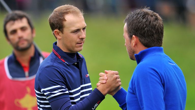 Graeme McDowell of Northern Ireland (R) shakes hands with Jordan Spieth of Team US after McDowell won his singles match at Gleneagles