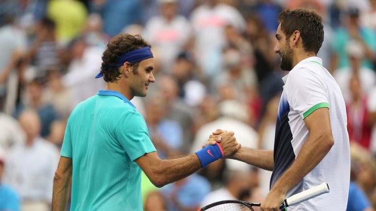 Roger Federer of Switzerland greets Marin Cilic (R) of Croatia after their men's singles semi-final