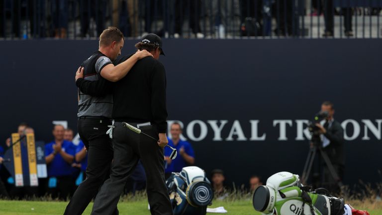 Henrik Stenson of Sweden celebrates victory as he walks off the 18th green with Phil Mickelson