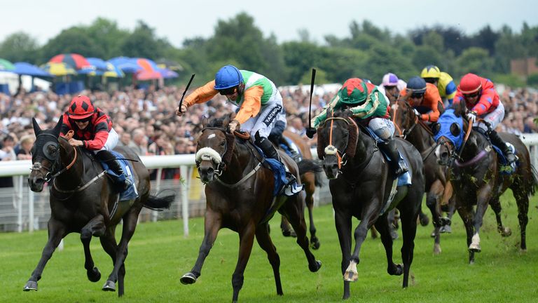 Home Cummins ridden by Paul Mulrennan (centre) beats Celestial Path ridden by Luke Morris (right) to win the John Smith's Racing Stakes during the John Smi
