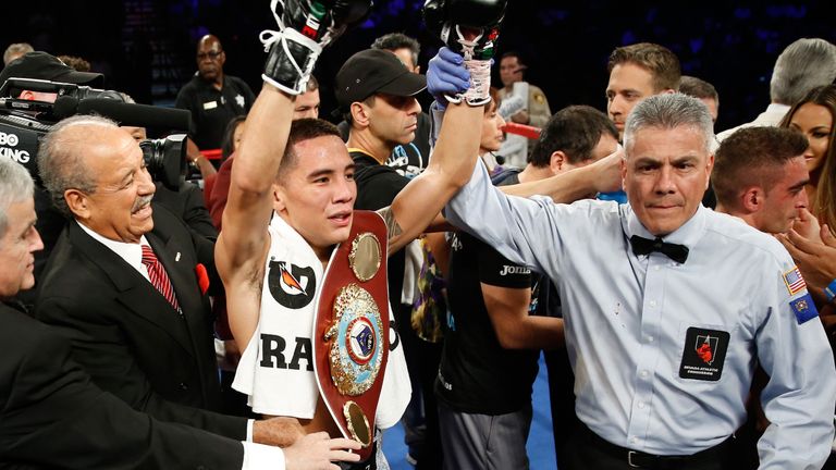  Oscar Valdez Jr. (C) of Mexico poses with the referee Russell Mora after defeating Matias Rueda of Argentina