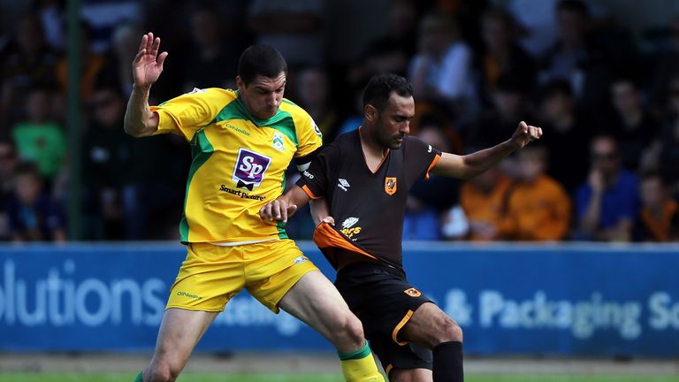 NORTH FERRIBY, ENGLAND - JULY 16:  Danny Clarke of North Ferriby United (L) challenges Ahmed Elmohamady of Hull City during the Pre-Season Friendly between