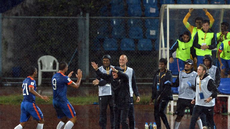 India's forward Robin Singh  (2L) celebrates with coach Stephen Constantine (C) during the the Asia Group D FIFA World Cup 2018 qualifier against Guam