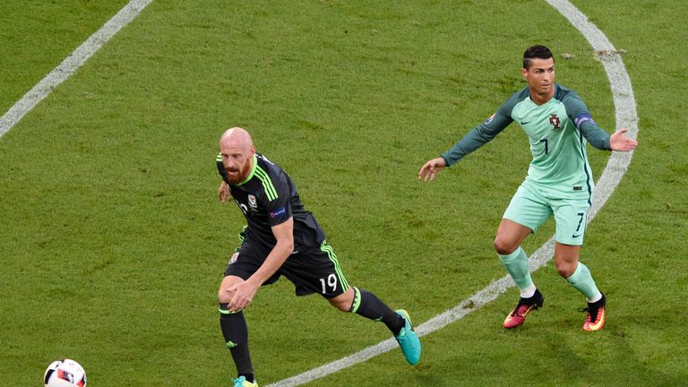 (LtoR) Wales' defender James Collins and Portugal's forward Cristiano Ronaldo vie for the ball during the Euro 2016 semi-final football match between Portu