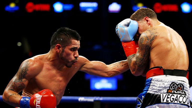 NEW YORK, NY - DECEMBER 05:  Jesus Cuellar (L) of Argentina punches Jonathan Oquendo of Puerto Rico during their WBA Featherweight Championship bout on Dec