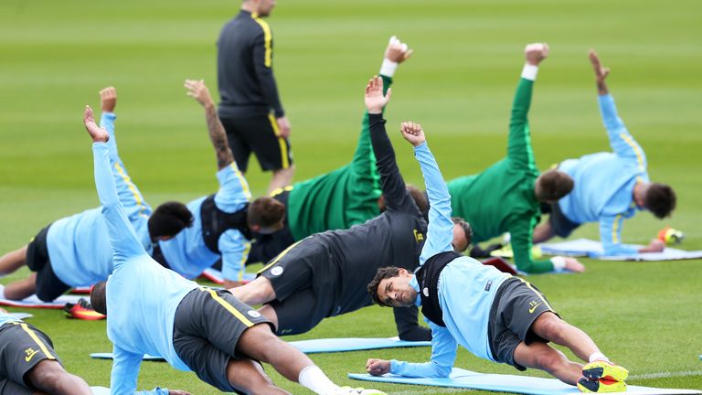 Manchester City's Jesus Navas (facing camera) joins in strength-building exercises during a training session at City Football Academy