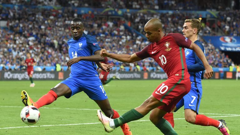 France's midfielder Blaise Matuidi (L) and Portugal's midfielder Joao Mario (C) fight for the ball next to France's forward Antoine Griezmann during the Eu