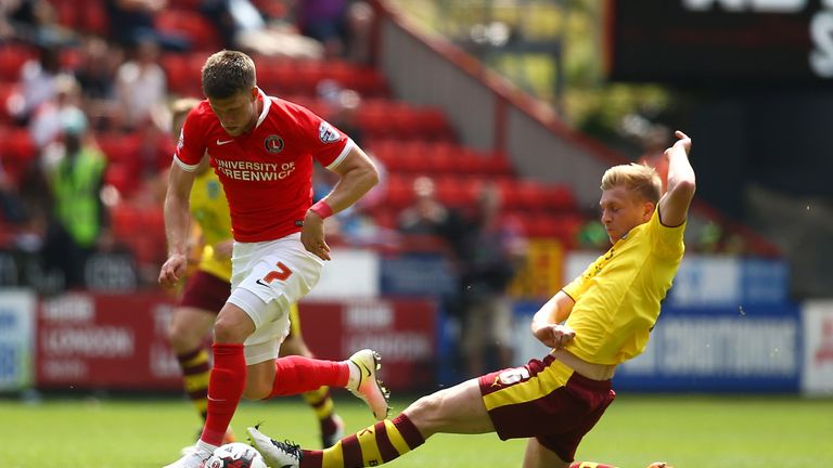 Johann Berg Gudmundsson of Charlton Athletic and Ben Mee of Burnley compete for the ball 
