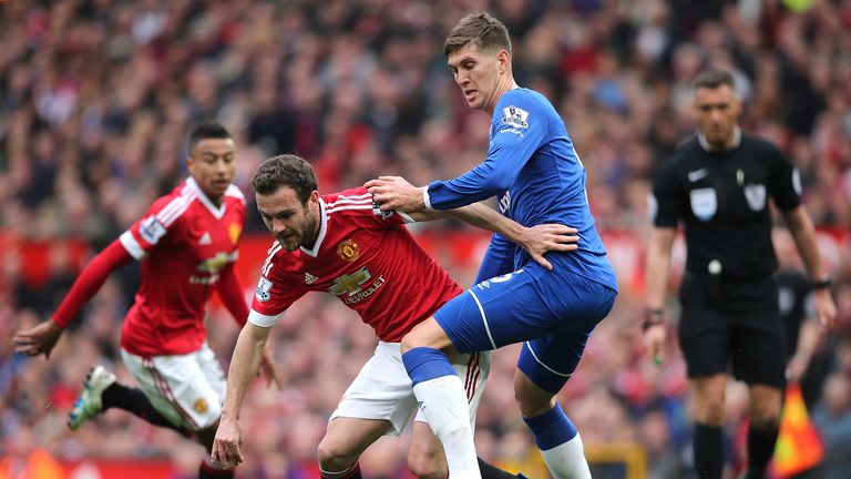 MANCHESTER, ENGLAND - APRIL 03:  John Stones of Everton challeneges Juan Mata of Manchester United during the Barclays Premier League match between Manches