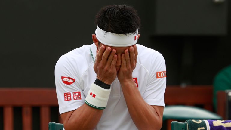 Kei Nishikori of Japan looks dejected during his fourth round match at Wimbledon. He was forced to retire against Marin Cilic due to injury.