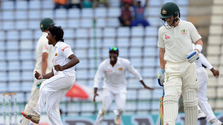 Sri Lanka's Lakshan Sandakan celebrates  after he dismissed Australia's Mitchell Starc