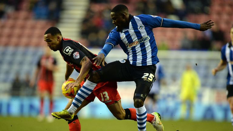 WIGAN, ENGLAND - FEBRUARY 07:  Leon Barnett of Wigan Athletic (R) challenges Callum Wilson of AFC Bournemouth during the Sky Bet Championship match between