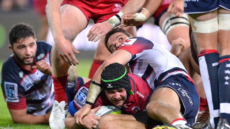Liam Gill of the Reds scores a try during the round 17 Super Rugby match between the Reds and the Rebels at Suncorp Stadium