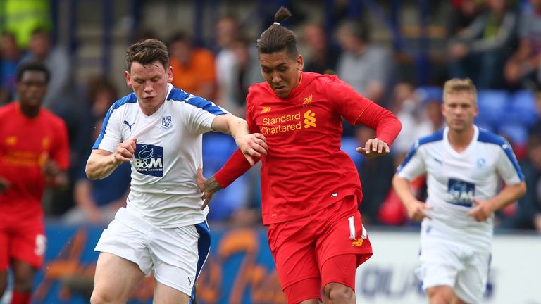 BIRKENHEAD, ENGLAND - JULY 08: Roberto Firmino of Liverpool gets past Connor Jennings of Tranmere Rovers during the Pre-Season Friendly match between Tranm