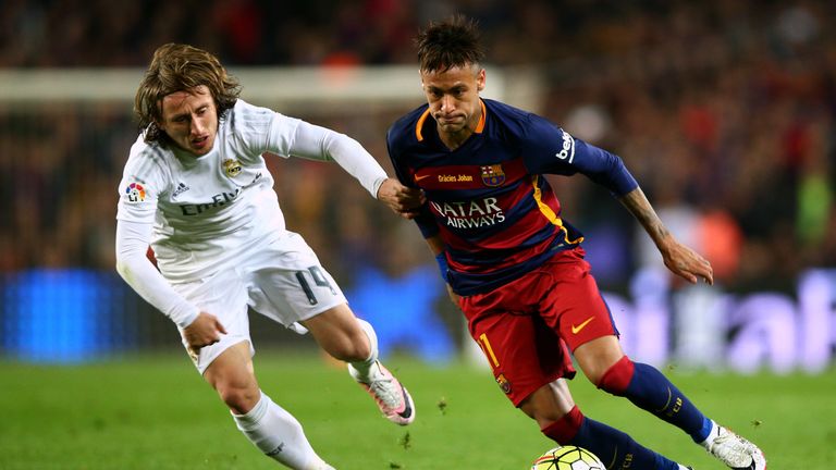 Neymar of Barcelona (right) battles for the ball with Luka Modric of Real Madrid