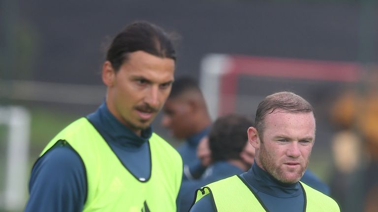 Zlatan Ibrahimovic and Wayne Rooney look on in training