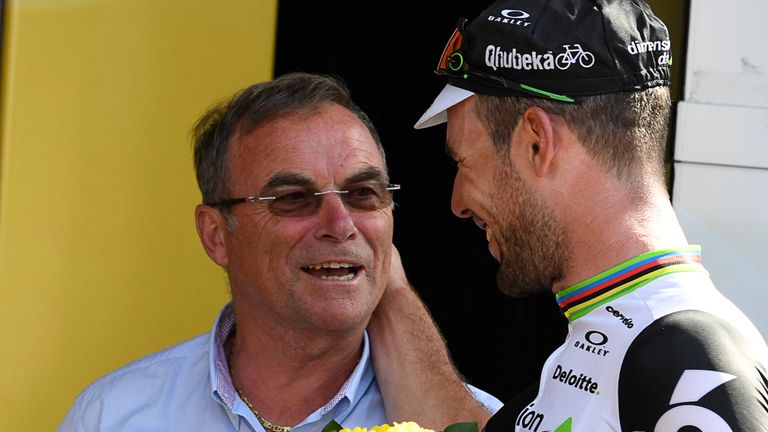 Stage winner Great Britain's Mark Cavendish (R) is congratulated by French former cyclist Bernard Hinault as he celebrates at the Tour de France