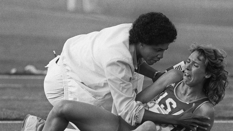 Mary Decker is comforted by a track official after falling during the 3000m final at the Los Angeles Olympic Games in 1984