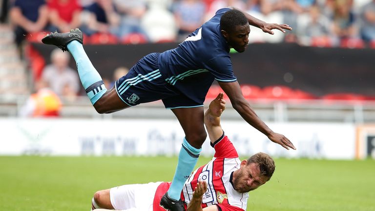 DONCASTER, ENGLAND - JULY 16:  Andy Butler of Doncaster Rovers FC collides with Mustapha Carayol of Middlesbrough FC during the pre-season friendly match b