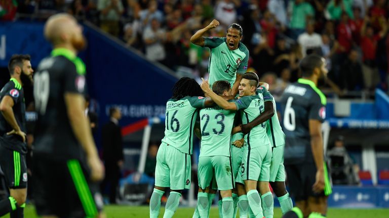 Bruno Alves (top) and Portugal players celebrate their team's second goal scored by Nani (obscured) during the UEFA EURO 2016 semi v Wales