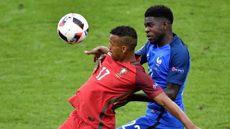 Portugal's forward Nani (L) and France's defender Samuel Umtiti vie for the ball during the Euro 2016 final football match between Portugal and France at t