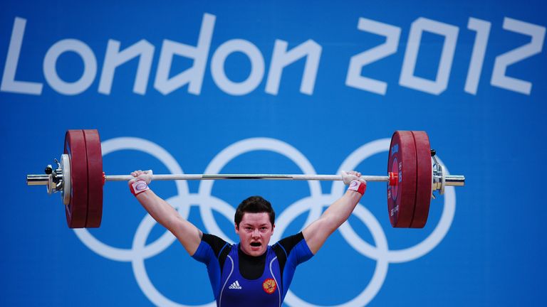 LONDON, ENGLAND - AUGUST 03:  Natalya Zabolotnaya of Russia lifts to set a new Olympic Record in the Women's 75kg Weightlifting Final on Day 7 of the Londo