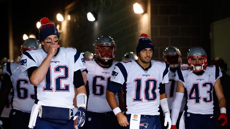 (L-R) Tom Brady #12, Jimmy Garoppolo #10 and  Nate Ebner #43 prepare to take the field for the Patriots