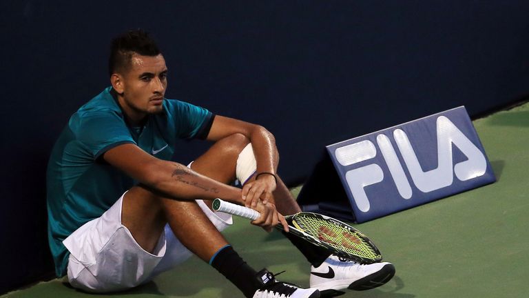 Nick Kyrgios sits at the end of the court and waits for the final game in his defeat to Denis Shapovalov