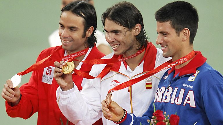 Silver medallist Fernando Gonzalez (L) of Chile, gold medallist Rafael Nadal (C) of Spain and bronze medallist Noval Djokovic (R) of Serbia pose together o