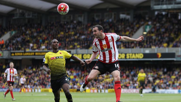 WATFORD, ENGLAND - MAY 15:  John O'Shea of Sunderland clears the ball from Odion Ighalo of Watford during the Barclays Premier League match between Watford