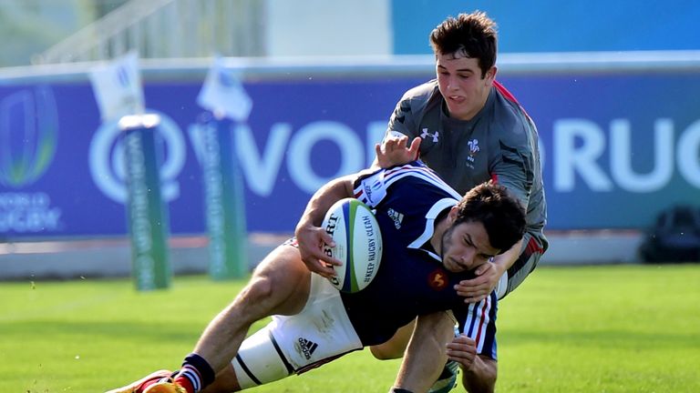 France's Arthur Bonneval is tackled by Wales' Owen Watkin during the World Rugby U20 Championship match between France and Wales, on June 2, 2015 at the "S