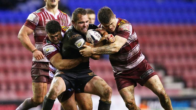 Catalan Dragons winger Pat Richards his challenged by two Wigan players