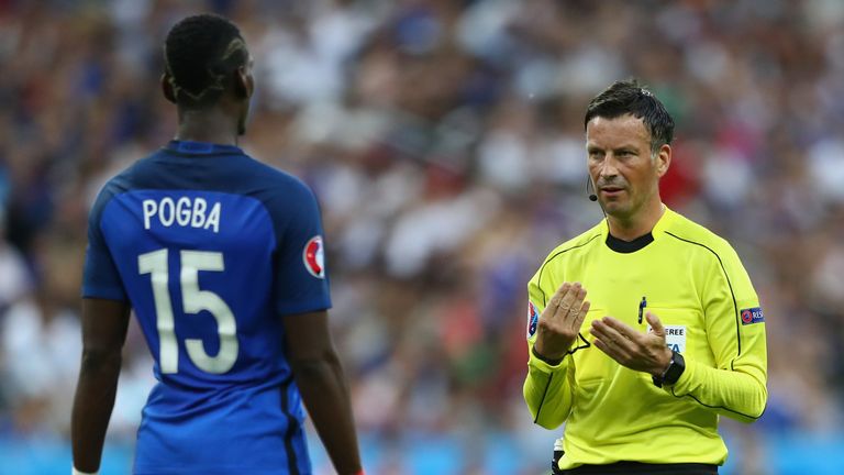 Referee Mark Clattenburg talks with Paul Pogba of France 