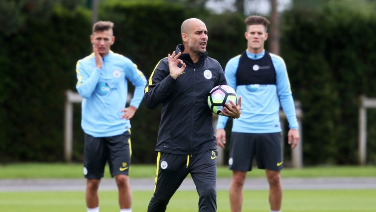 Manchester City manager Pep Guardiola (centre) during a training session at City Football Academy