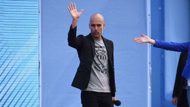 Pep Guardiola waves as he speaks to Manchester City fans 