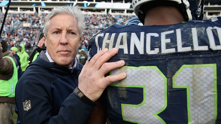 CHARLOTTE, NC - JANUARY 17:  Head coach Pete Carroll talks with  Kam Chancellor #31 of the Seattle Seahawks after losing to the Carolina Panthers 31-24 at 